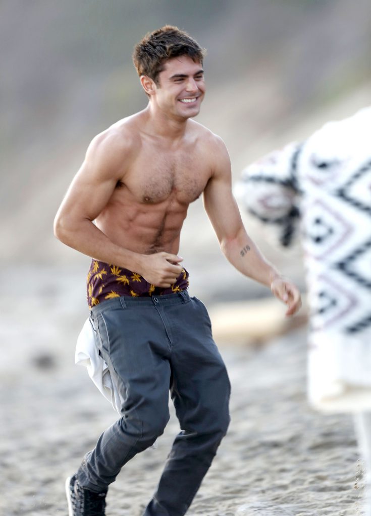 51526850 Actor Zac Efron shows off his toned torso between takes as he films scenes for his new movie 